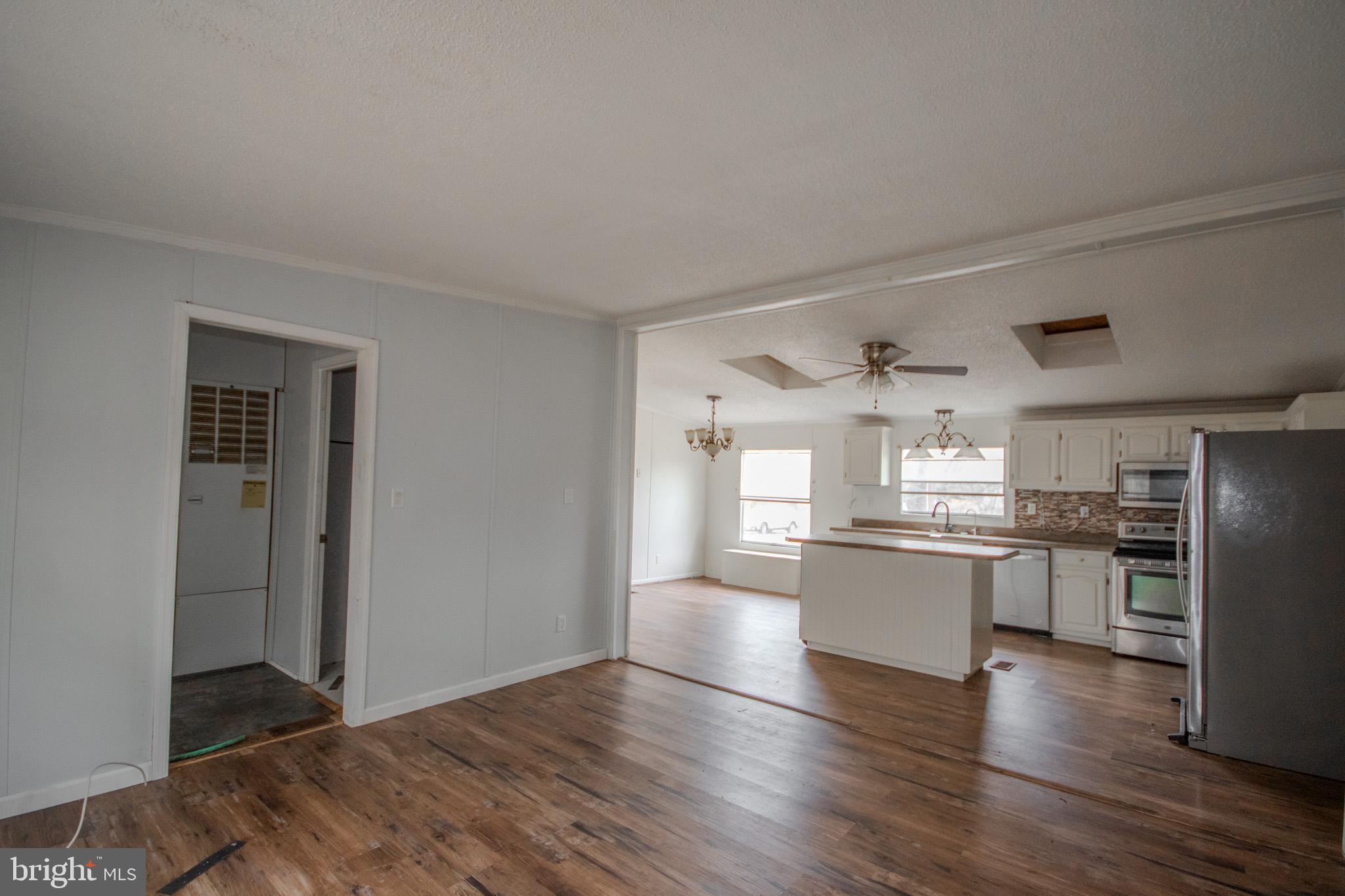 3887 Texas Road Bivalve, MD 21814 - Photo 15 of 34 a kitchen with stainless steel appliances a refrigerator sink and stove
