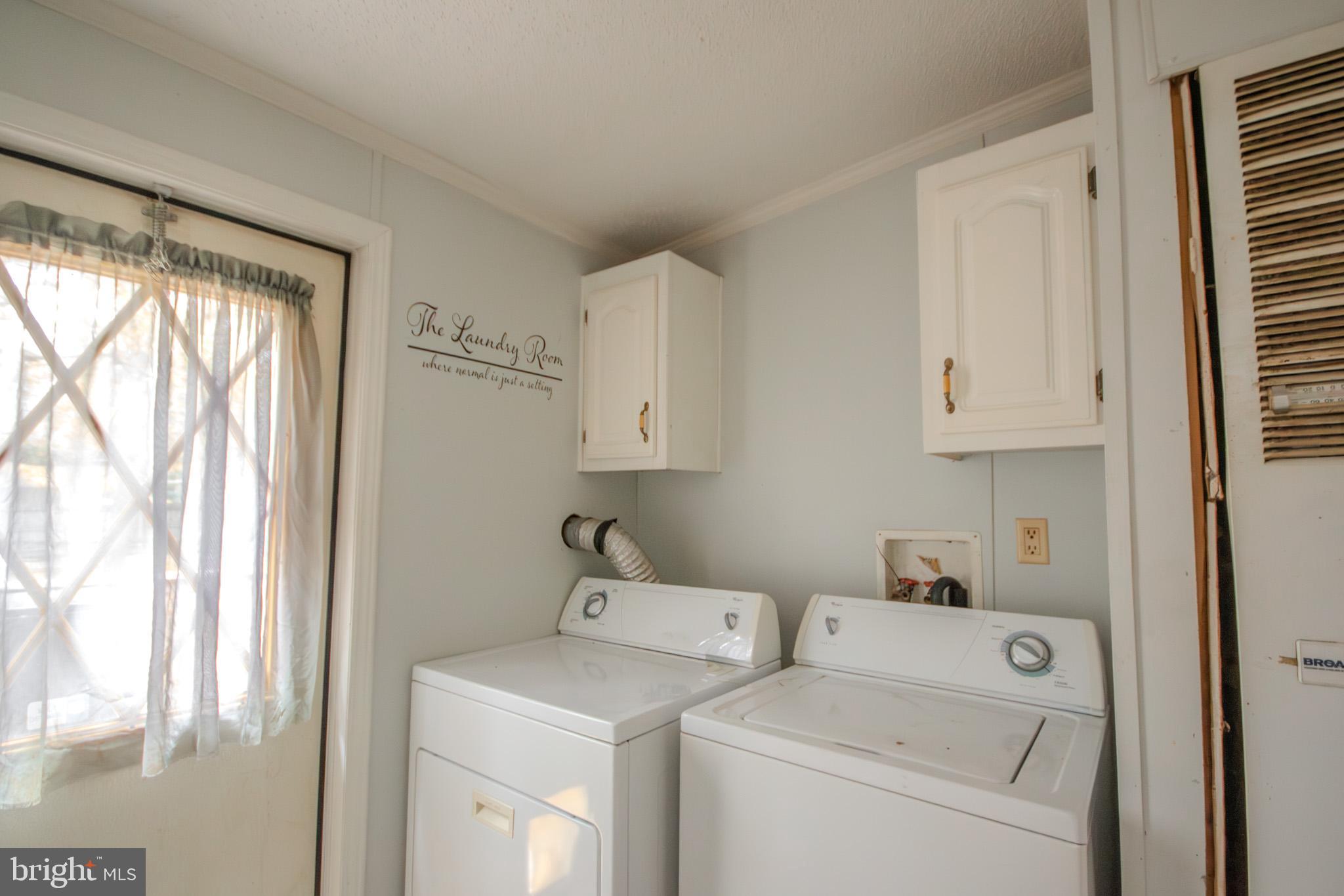 3887 Texas Road Bivalve, MD 21814 - Photo 25 of 34 a view of storage and utility room with washer and dryer