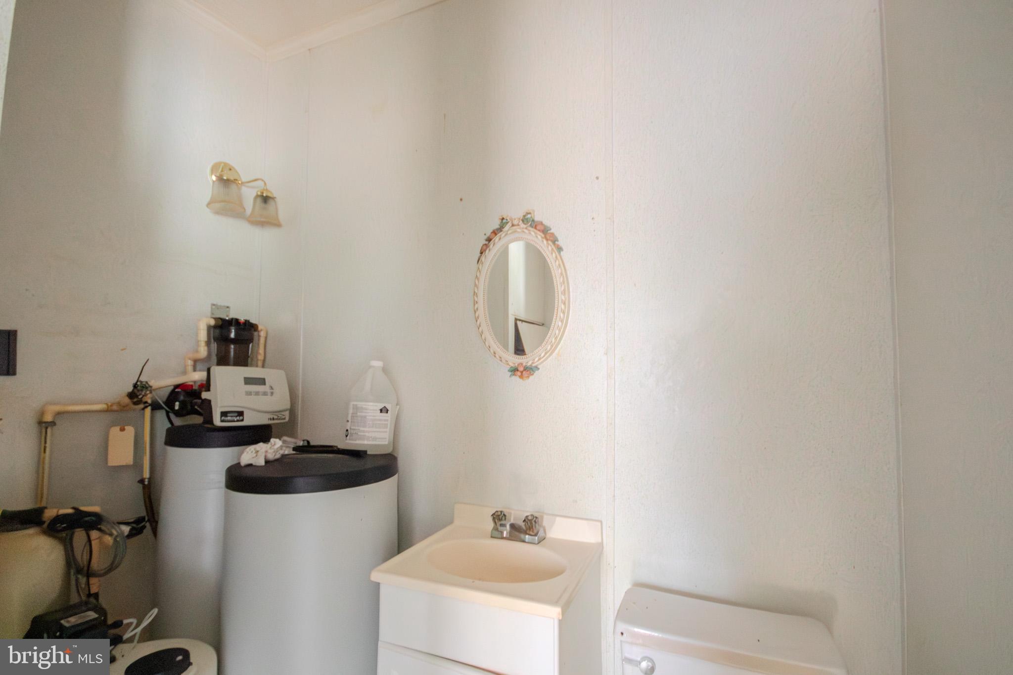3887 Texas Road Bivalve, MD 21814 - Photo 26 of 34 a bathroom with a sink and a mirror