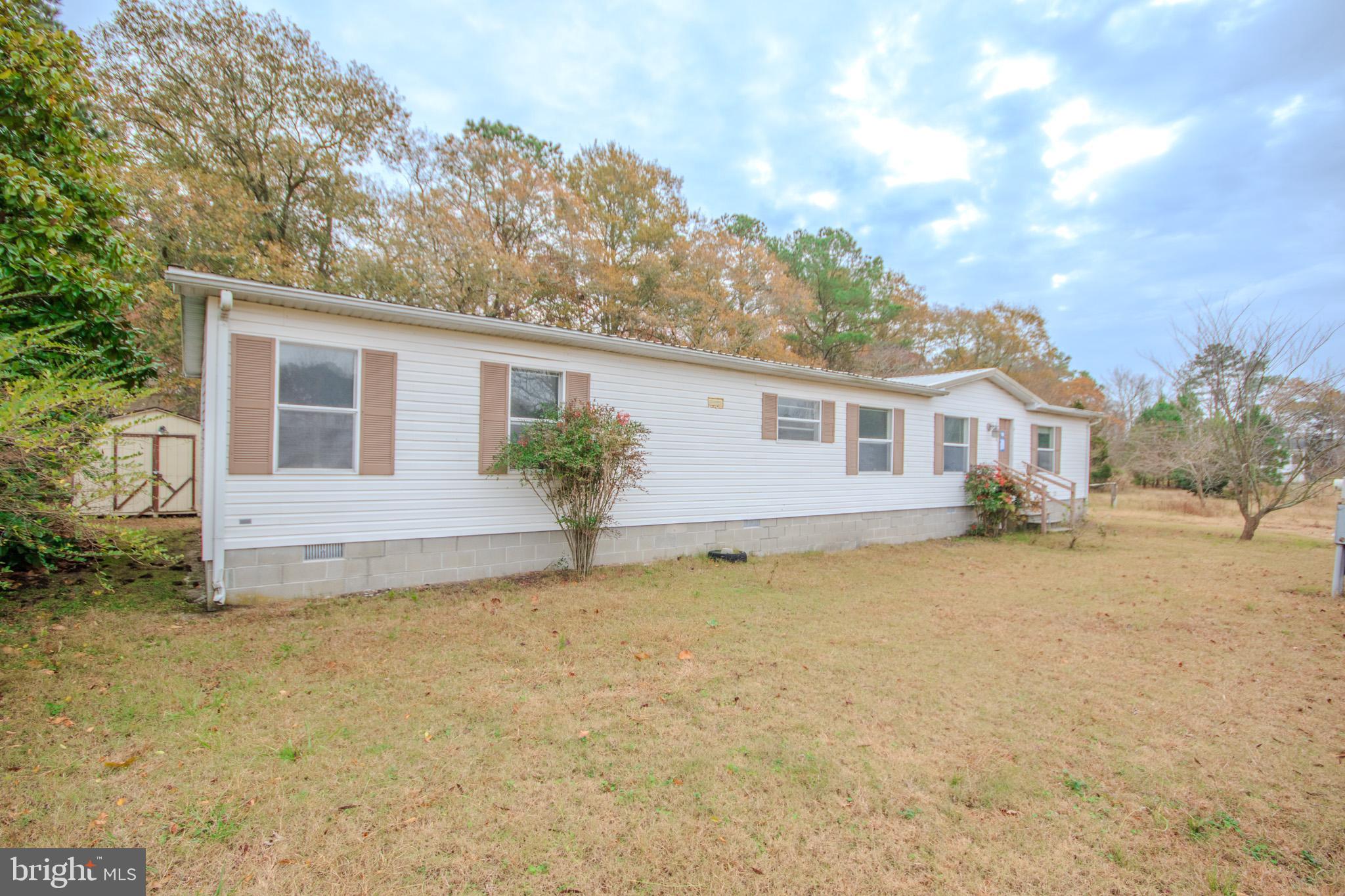 3887 Texas Road Bivalve, MD 21814 - Photo 3 of 34 a front view of a house with a yard