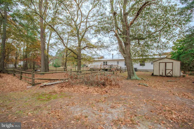 a view of a house with a yard covered in snow