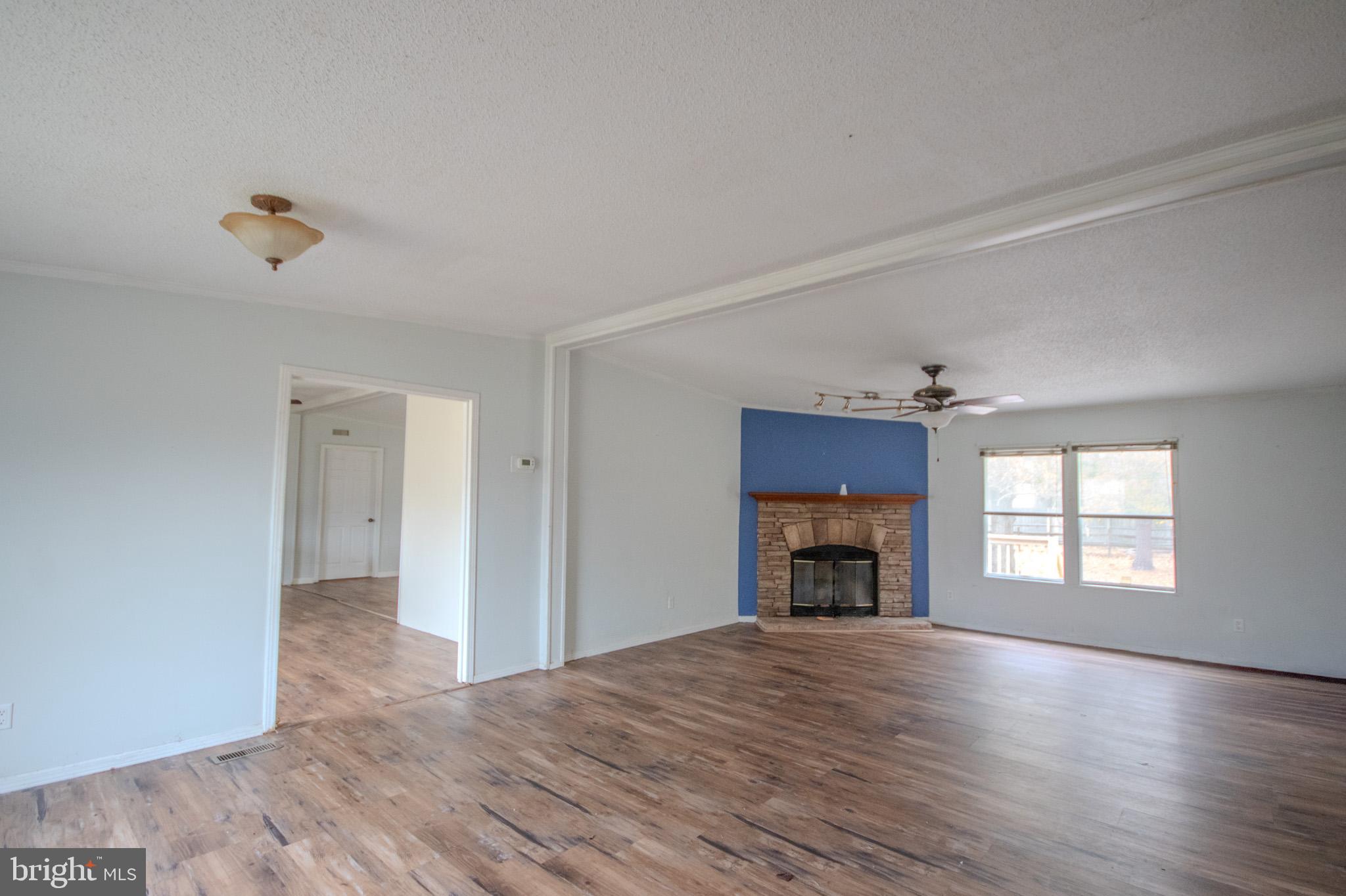 3887 Texas Road Bivalve, MD 21814 - Photo 6 of 34 an empty room with windows and a fireplace