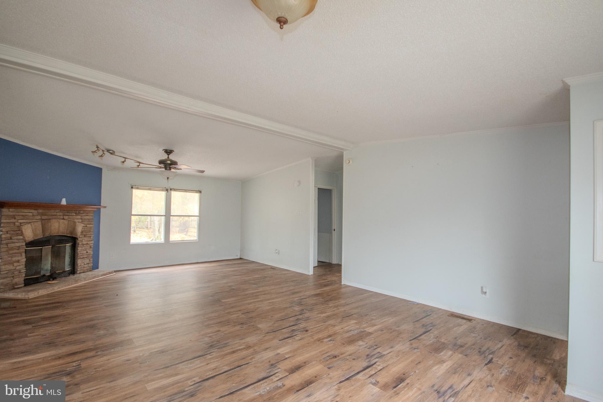 3887 Texas Road Bivalve, MD 21814 - Photo 7 of 34 an empty room with wooden floor and windows