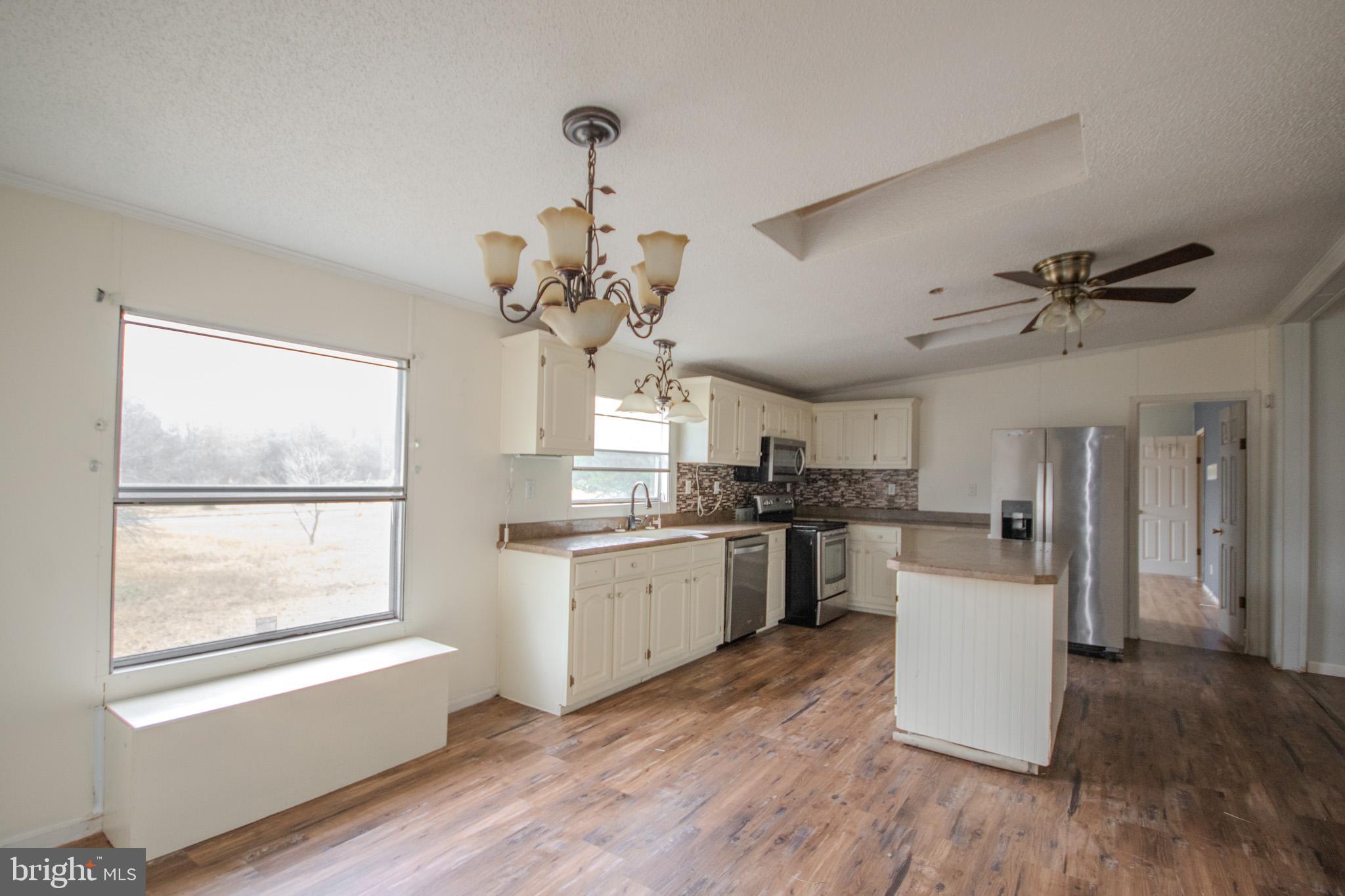 3887 Texas Road Bivalve, MD 21814 - Photo 9 of 34 a kitchen with a counter space cabinets and appliances