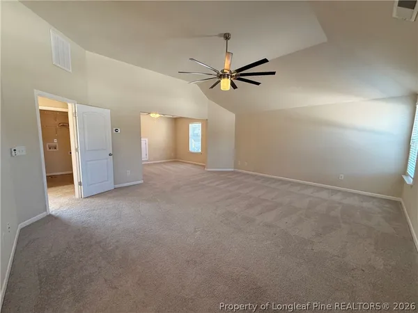 a view of a big room with closet and windows