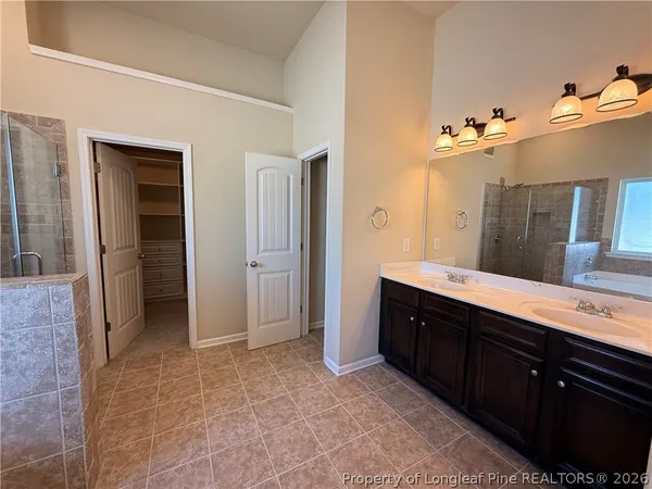 a spacious bathroom with a double vanity sink and a mirror