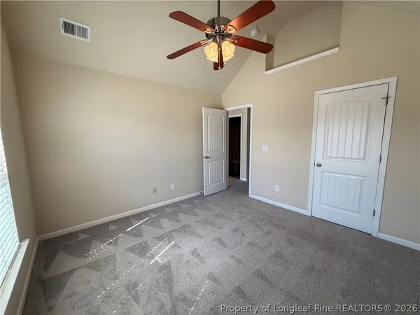 a view of a livingroom with a ceiling fan and window