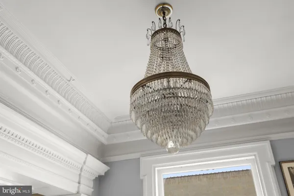 a living room with furniture a chandelier and a table