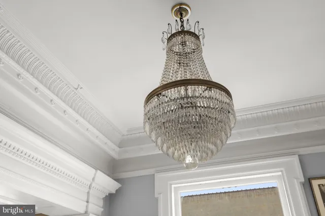 a living room with furniture a chandelier and a table