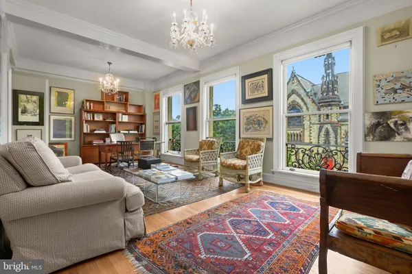 a living room with furniture a rug and a window