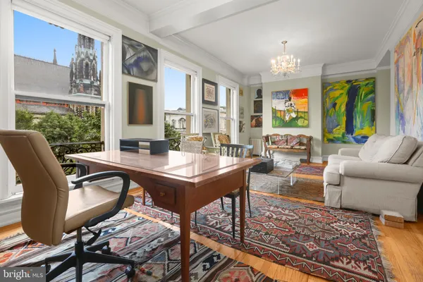 a view of a dining room with furniture and chandelier