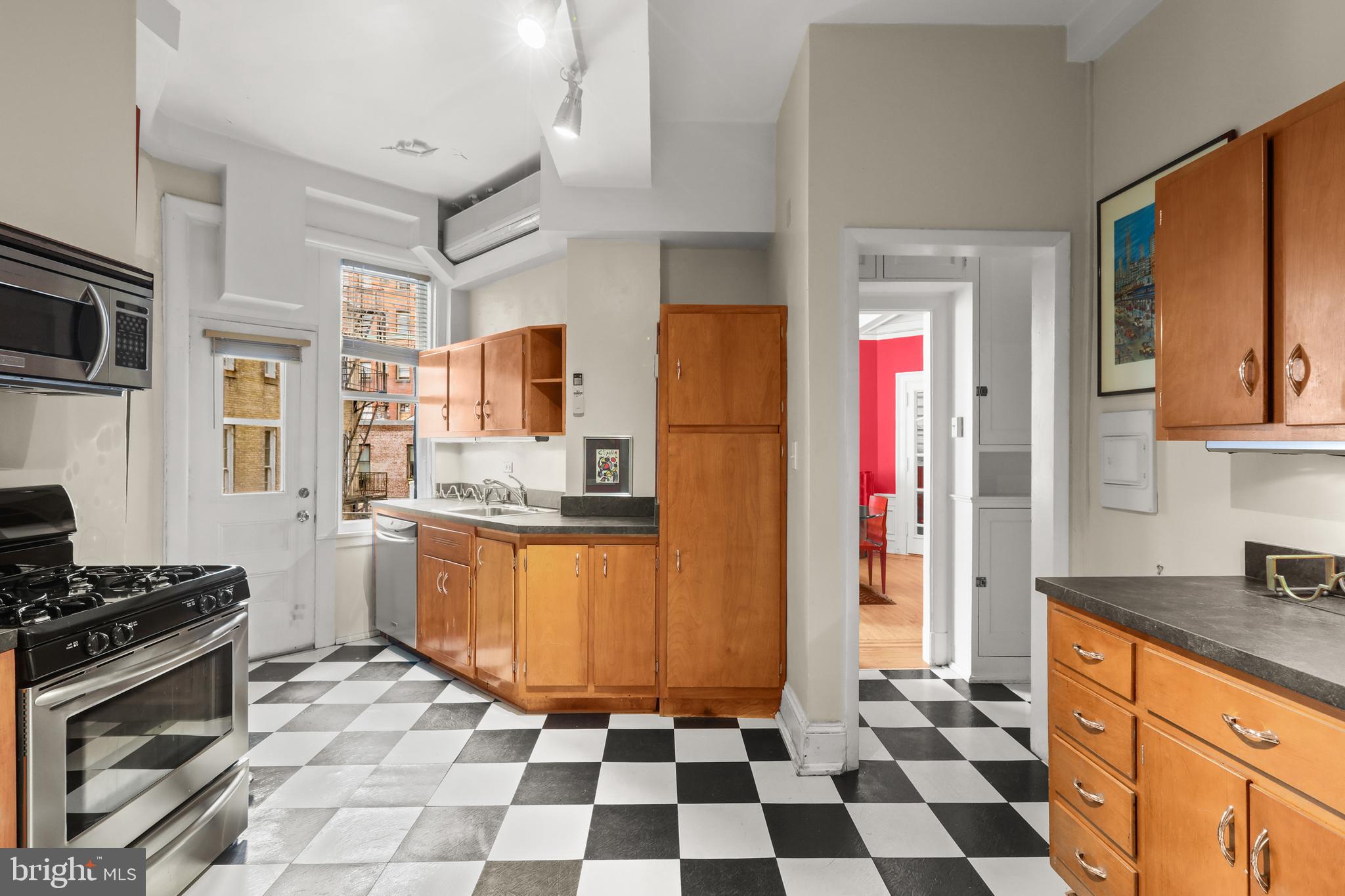 700 Washington Place, Unit 3B Baltimore, MD 21201 - Photo 28 of 43 a kitchen with stainless steel appliances granite countertop a refrigerator and a stove top oven