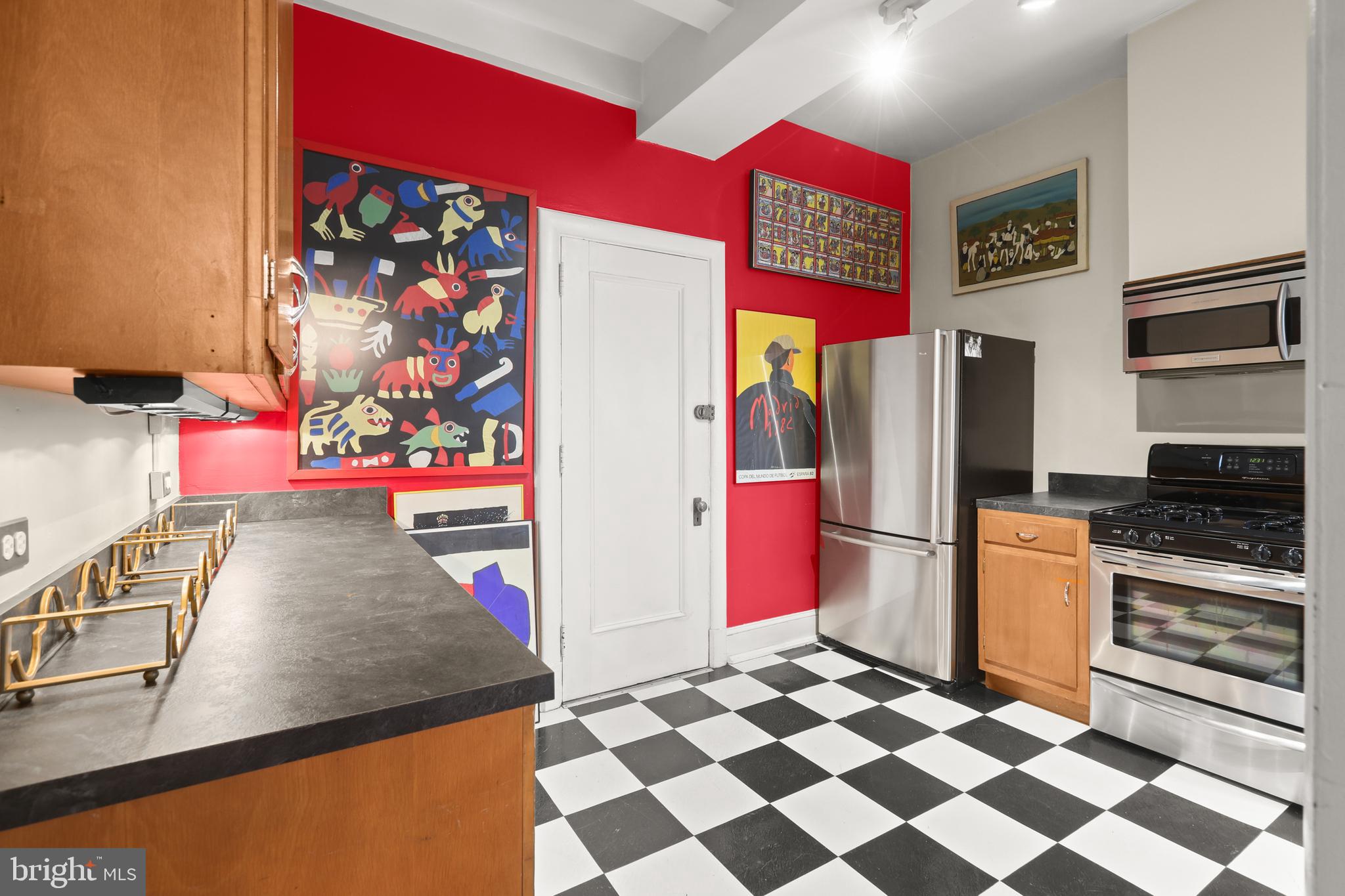 700 Washington Place, Unit 3B Baltimore, MD 21201 - Photo 29 of 43 a kitchen with stainless steel appliances granite countertop a refrigerator and a stove top oven