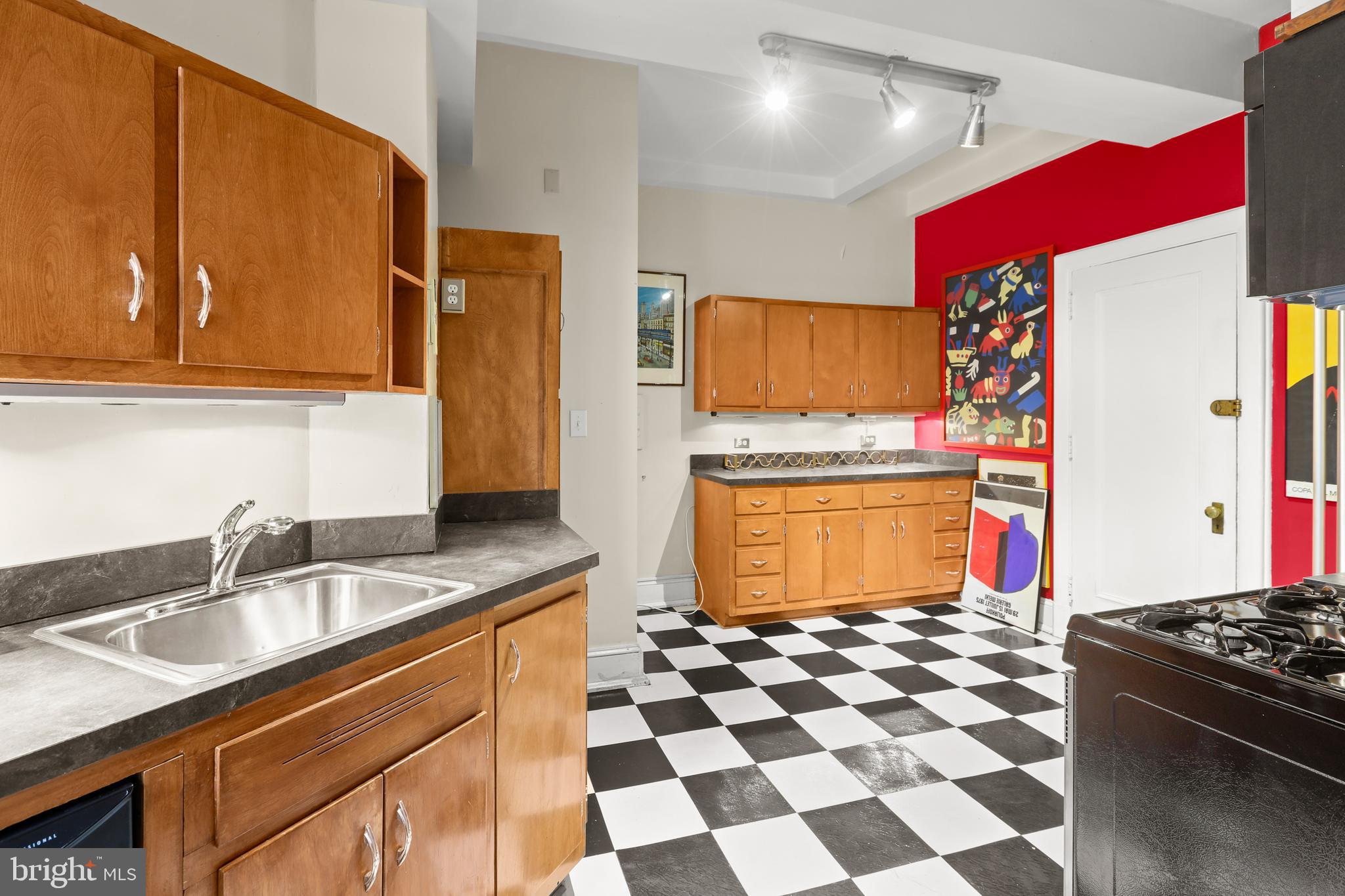 700 Washington Place, Unit 3B Baltimore, MD 21201 - Photo 30 of 43 a kitchen with granite countertop a sink cabinets and stainless steel appliances