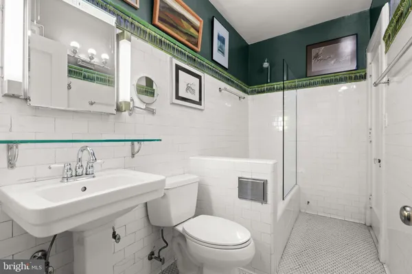 a bathroom with a toilet sink and a shower