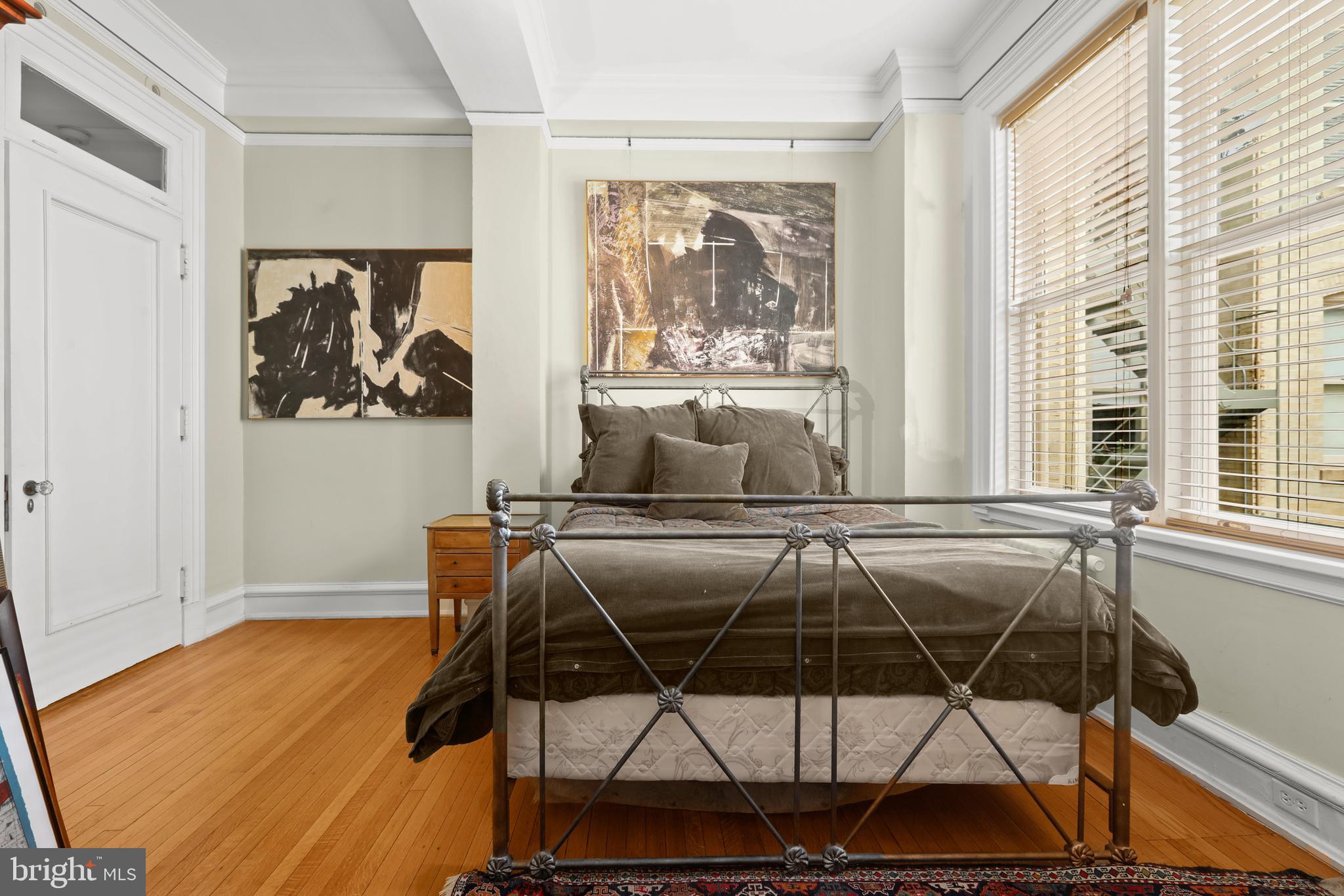 700 Washington Place, Unit 3B Baltimore, MD 21201 - Photo 34 of 43 a bedroom with a bed and wooden floor