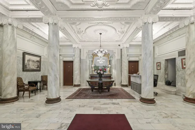 a living room with furniture a rug and a large window