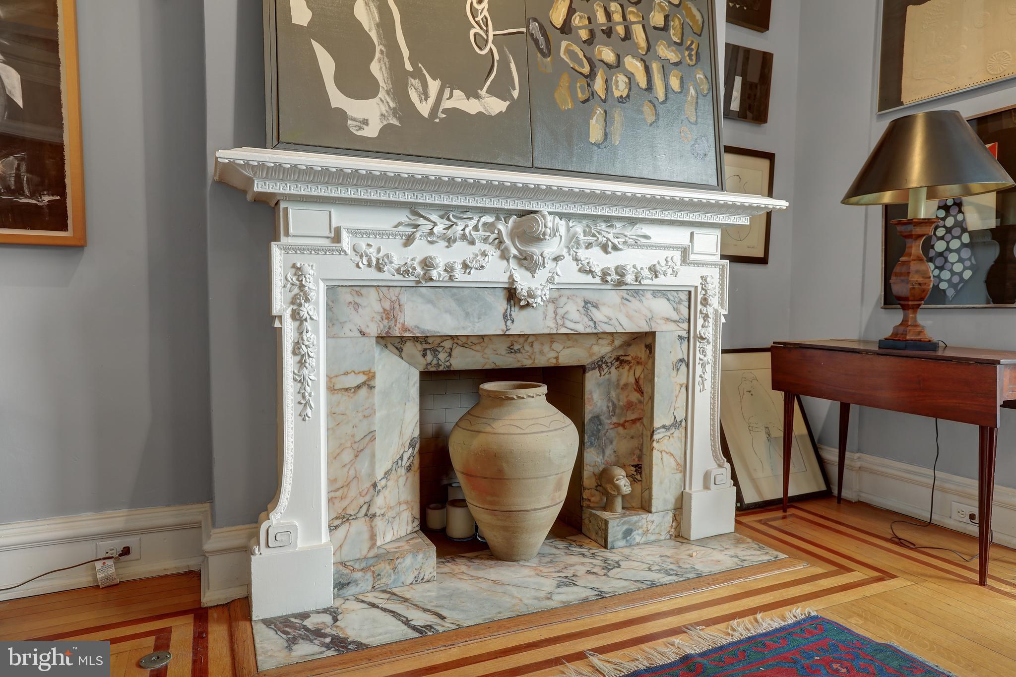 700 Washington Place, Unit 3B Baltimore, MD 21201 - Photo 8 of 43 a living room with a fireplace and a table