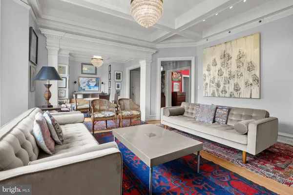 a living room with furniture and a chandelier