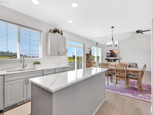 a large kitchen with a table and chairs in it