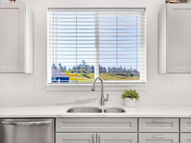 a kitchen with a window a sink and cabinets