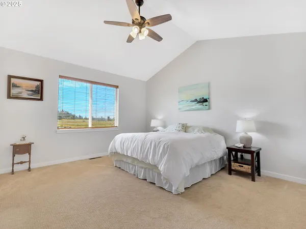 a spacious bedroom with a bed and a window