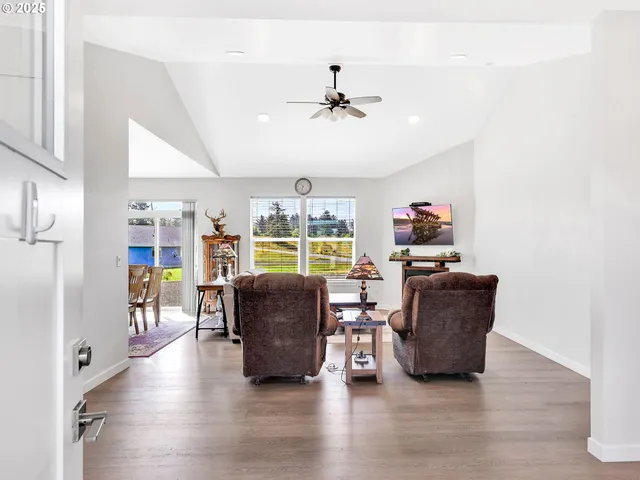 a living room with furniture and a floor to ceiling window