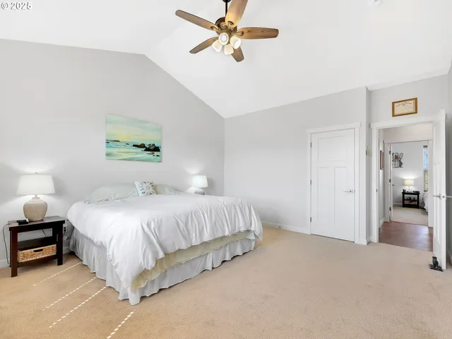 a spacious bedroom with a bed and a chandelier