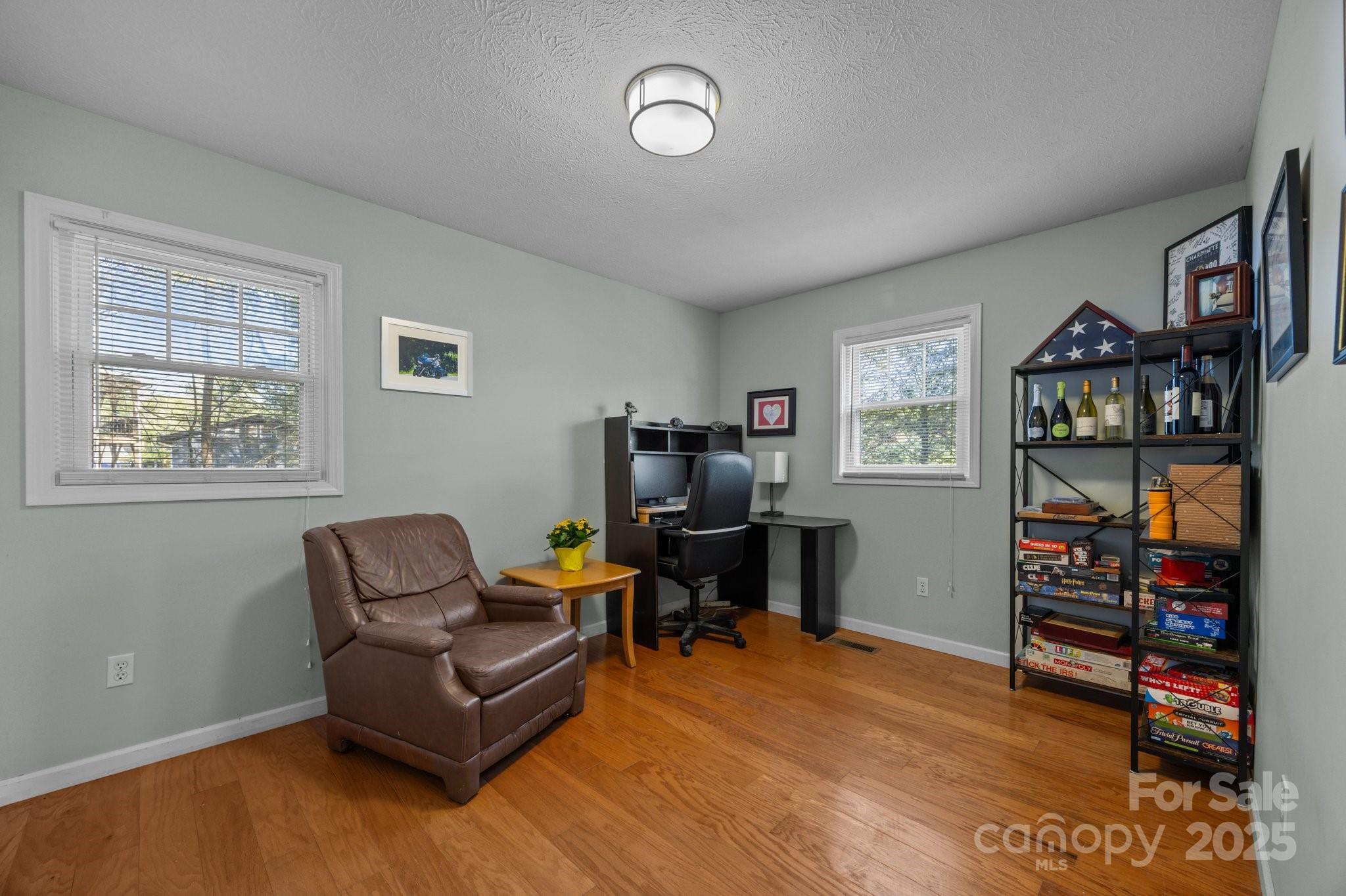 25 Alpine Way Clyde, NC 28721 - Photo 11 of 23 a living room with furniture a bookshelf and a window