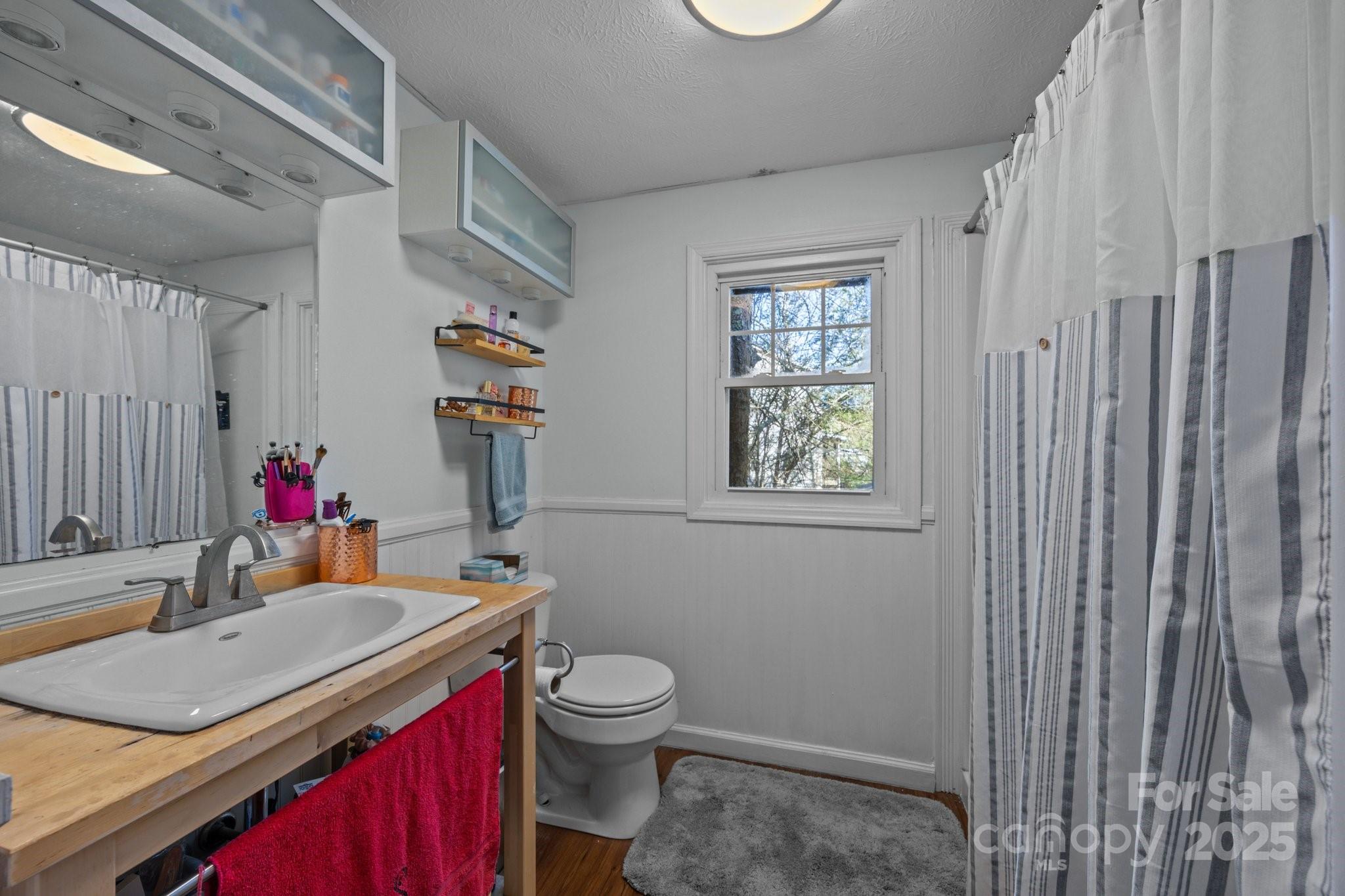 25 Alpine Way Clyde, NC 28721 - Photo 18 of 23 a bathroom with a sink toilet vanity and tub