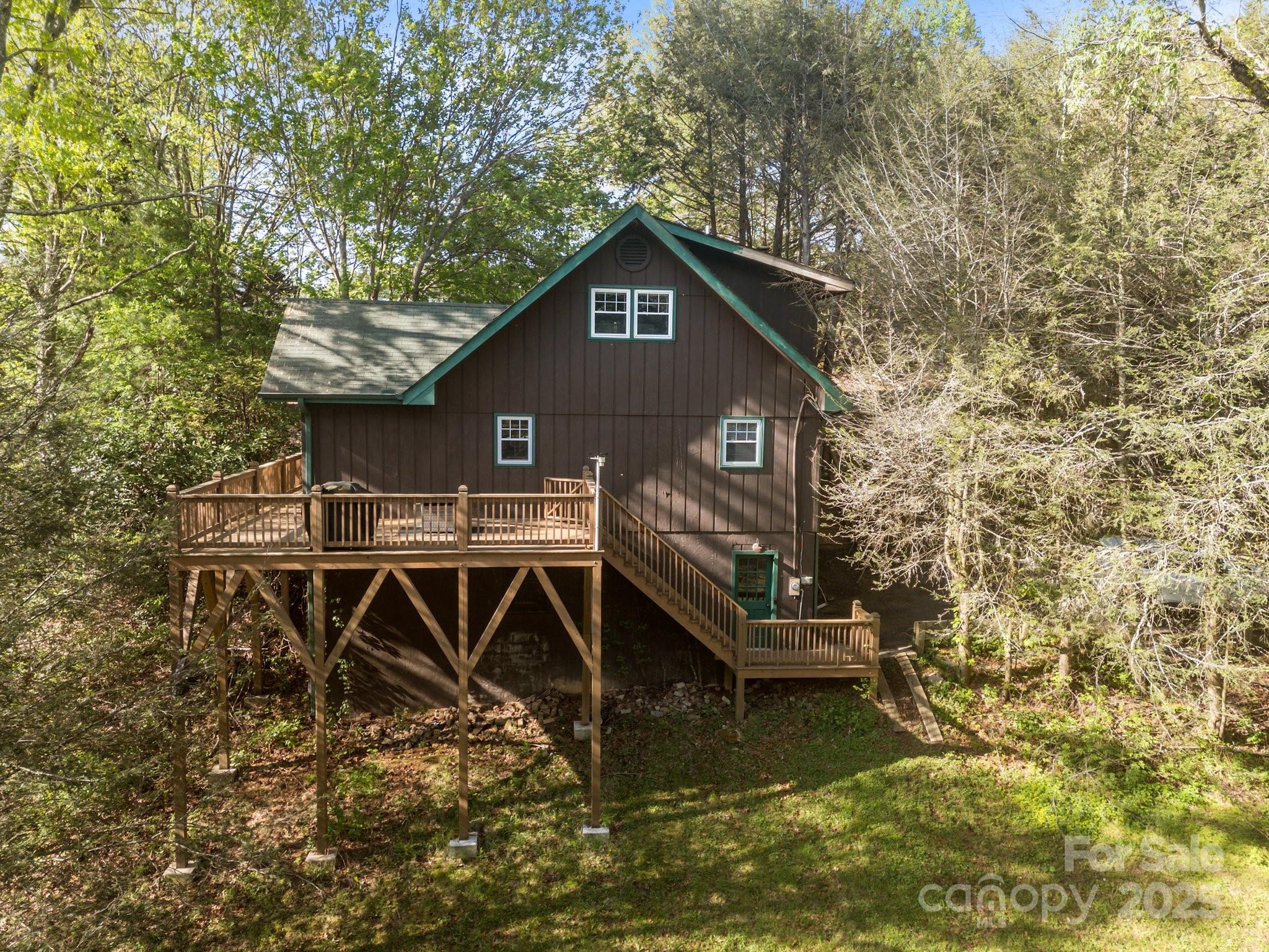 25 Alpine Way Clyde, NC 28721 - Photo 4 of 23 a house with river in front of it