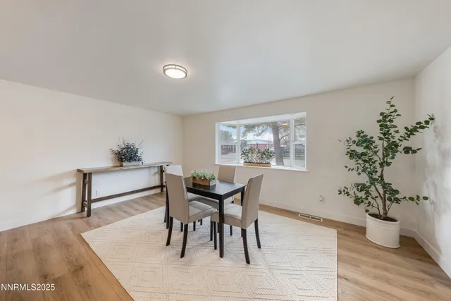 a view of a work space with furniture and wooden floor