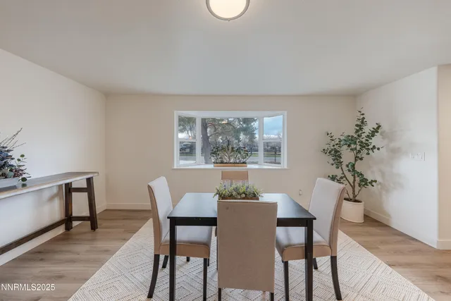 a view of a dining room with furniture and window
