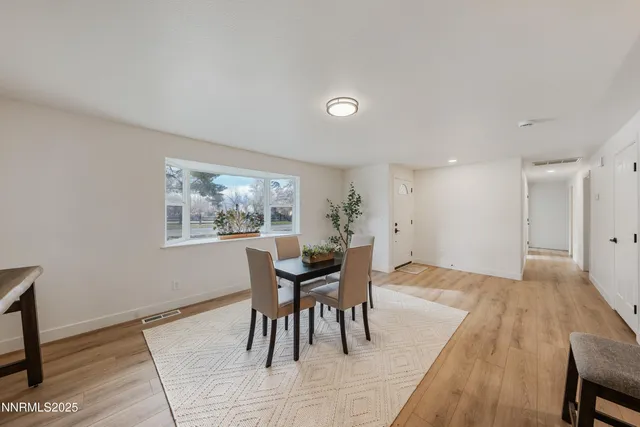 a dining room with furniture and window