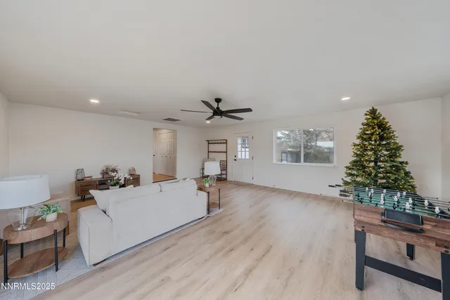 a living room with furniture and a christmas tree