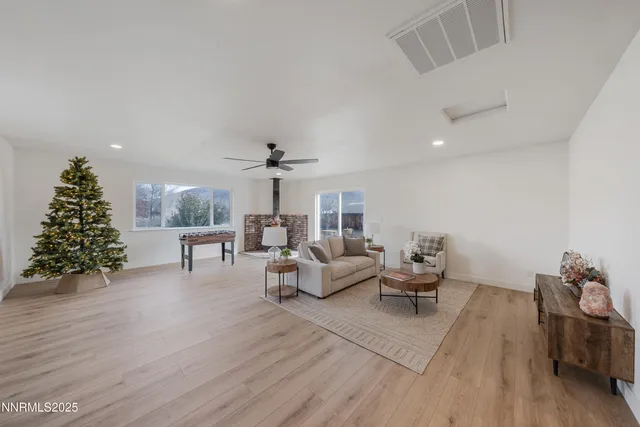 a living room with furniture and a christmas tree