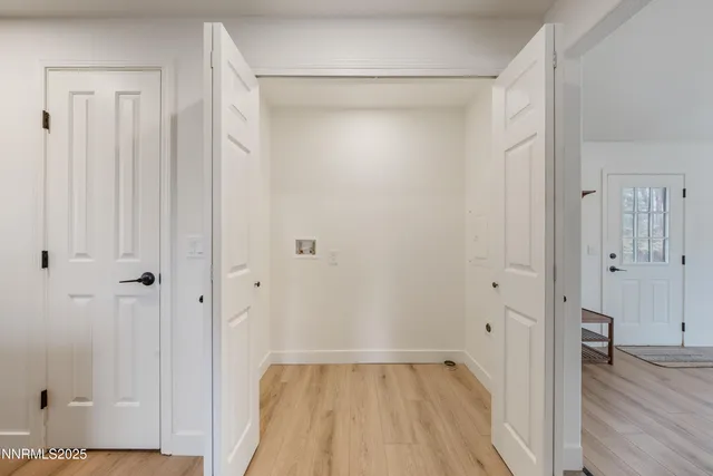 a view of a room with wooden floor