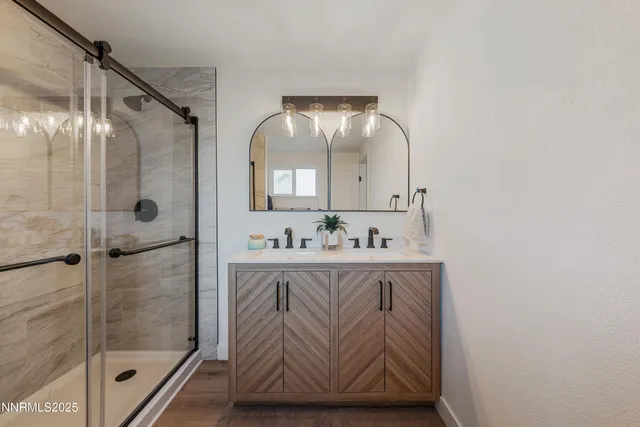 a bathroom with a sink vanity granite and a mirror