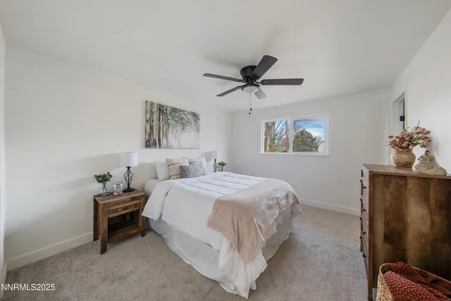 a bedroom with a bed and a painting on the wall