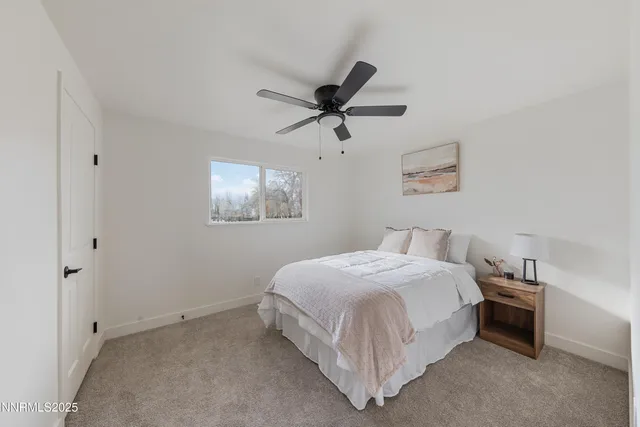 a bedroom with a bed and a ceiling fan