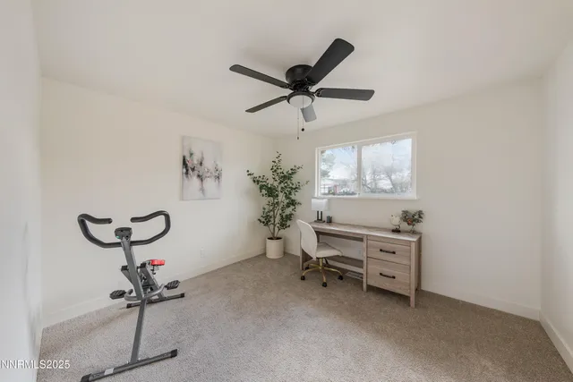 a room with a window and a ceiling fan