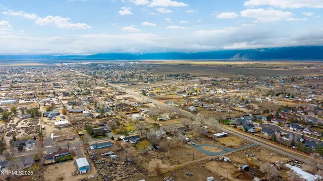 a view of a lake with table and chairs