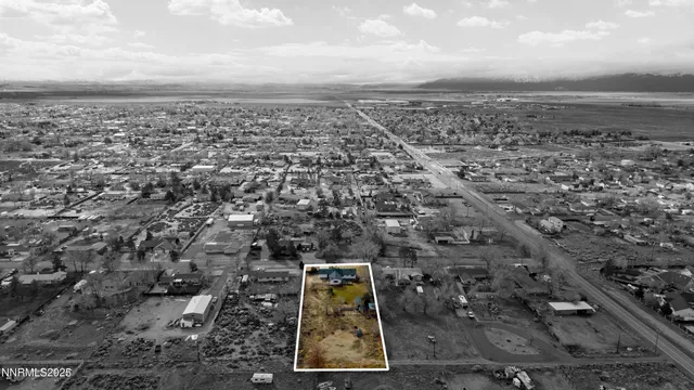 an aerial view of a house with a yard