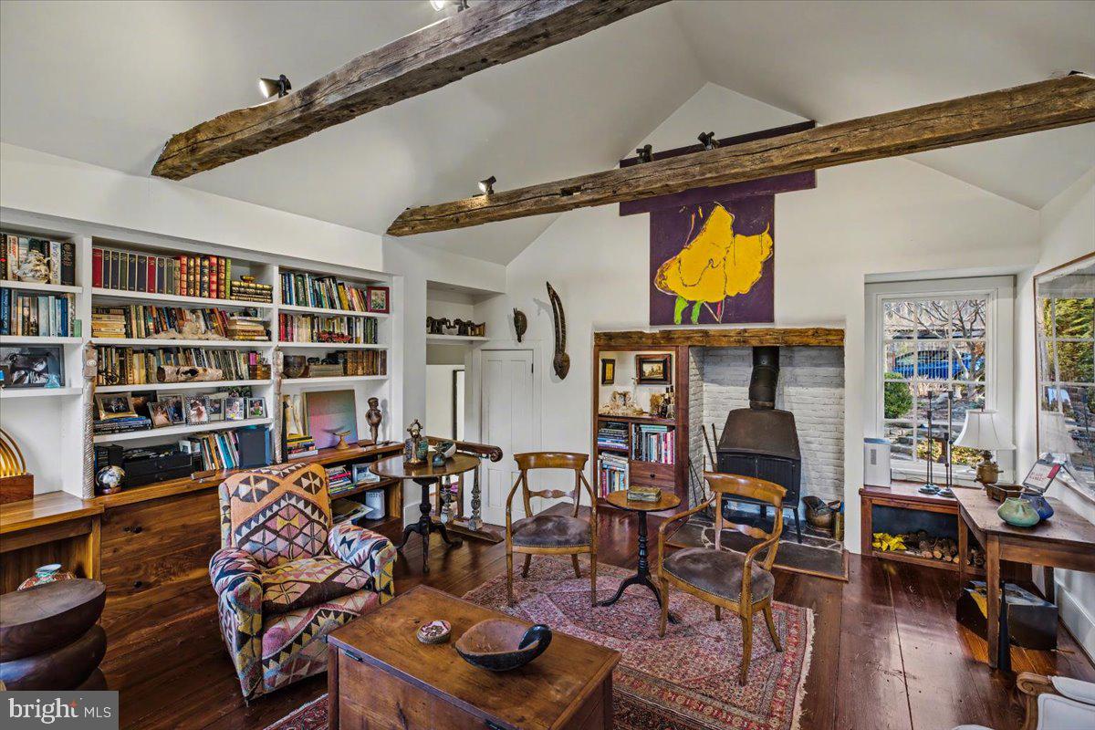 6338 Old Carversville Road Carversville, PA 18913 - Photo 11 of 56 a living room with furniture a rug and a bookshelf
