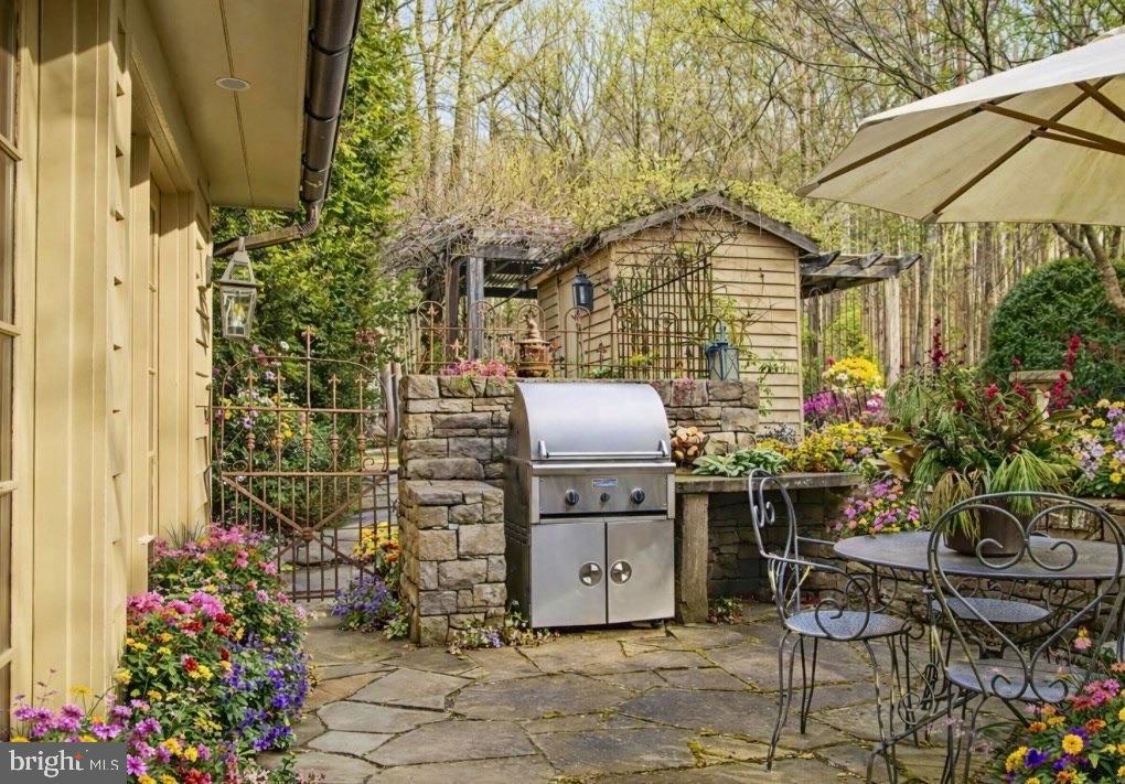 6338 Old Carversville Road Carversville, PA 18913 - Photo 3 of 56 a backyard of a house with table and chairs and potted plants