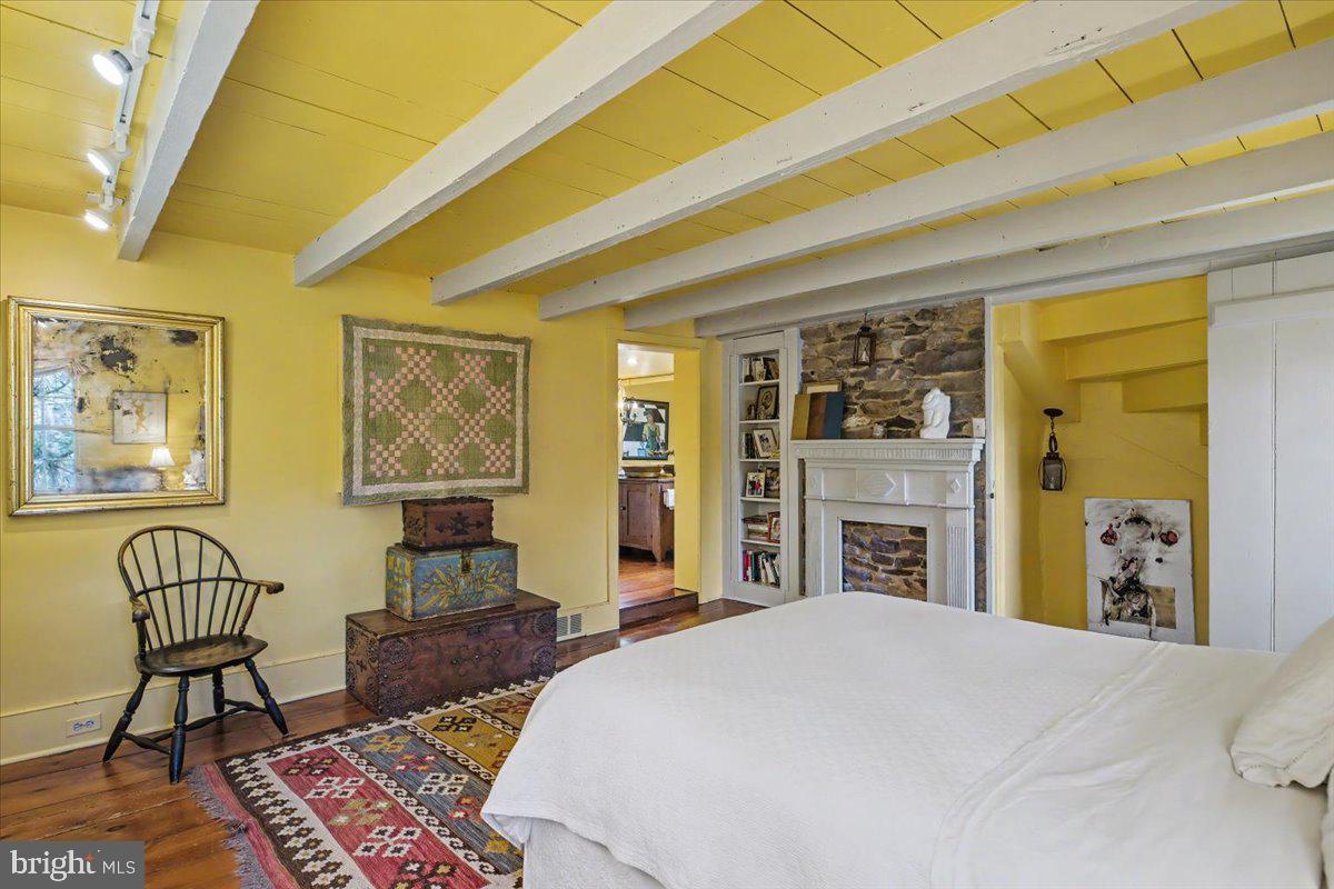 6338 Old Carversville Road Carversville, PA 18913 - Photo 39 of 56 a bedroom with a bed and wooden floor