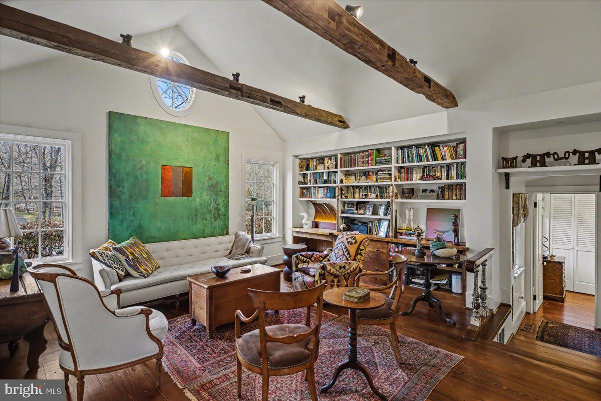 6338 Old Carversville Road Carversville, PA 18913 - Photo 10 of 56 a living room with furniture a bookshelf and a large window
