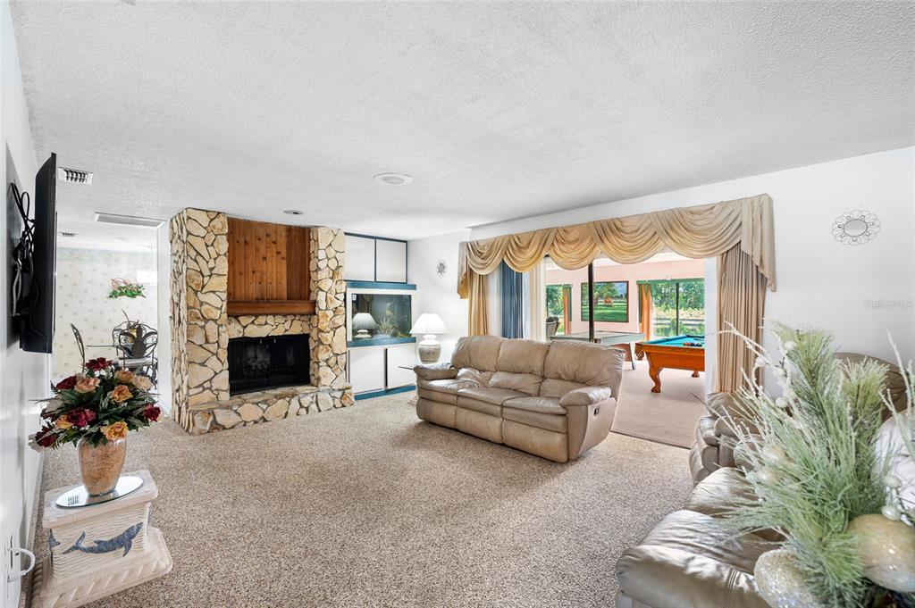 34 Misty Meadow Lane Mulberry, FL 33860 - Photo 11 of 49 a living room with furniture a fireplace and a large window