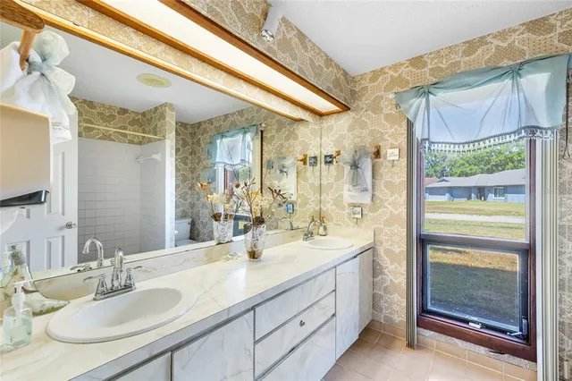 a bathroom with a granite countertop sink mirror and