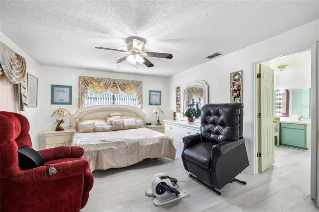a bedroom with furniture a bed and a chandelier